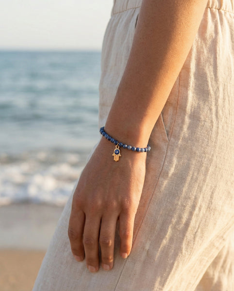 Handmade natural Lapis Lazuli healing bracelet with deep blue gemstone beads and gold pyrite flecks. A spiritual jewelry piece for wisdom, truth, and Third Eye Chakra healing by Oneness Living. 100% vegan.