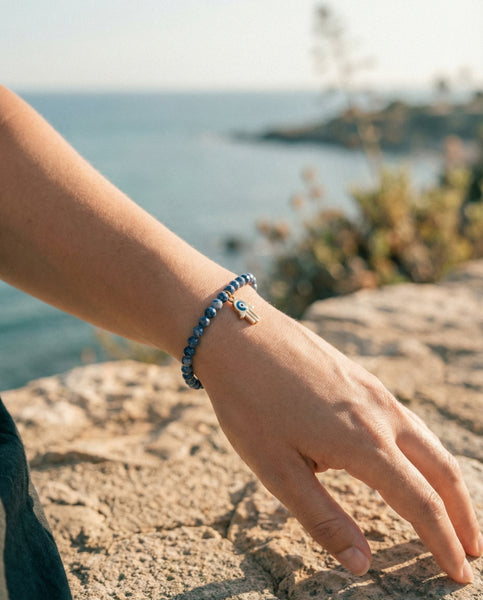 Handmade natural Lapis Lazuli healing bracelet with deep blue gemstone beads and gold pyrite flecks. A spiritual jewelry piece for wisdom, truth, and Third Eye Chakra healing by Oneness Living. 100% vegan.