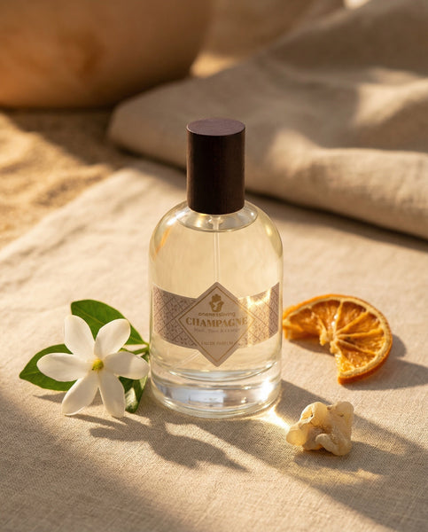 Luxury 100ml bottle of Champagne Eau de Parfum by Oneness Living. A sparkling and radiant feminine fragrance with notes of orange, tiaré flowers, and warm vanilla.
