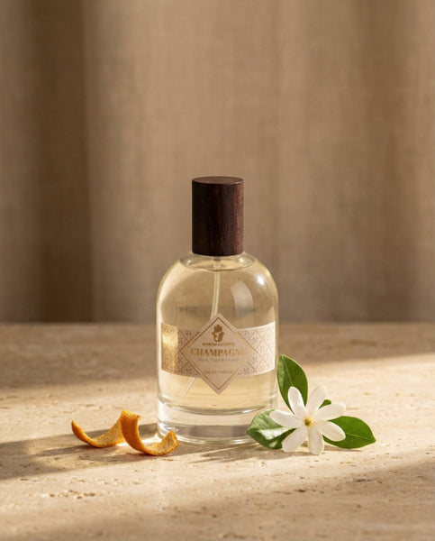 Luxury 100ml bottle of Champagne Eau de Parfum by Oneness Living. A sparkling and radiant feminine fragrance with notes of orange, tiaré flowers, and warm vanilla.