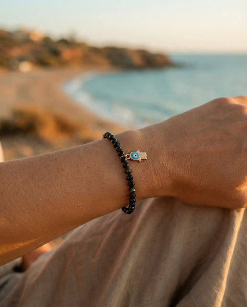 Handmade natural Black Obsidian healing bracelet for grounding and protection. A spiritual shield against negative energy, featuring genuine volcanic glass beads by Oneness Living. 100% vegan.