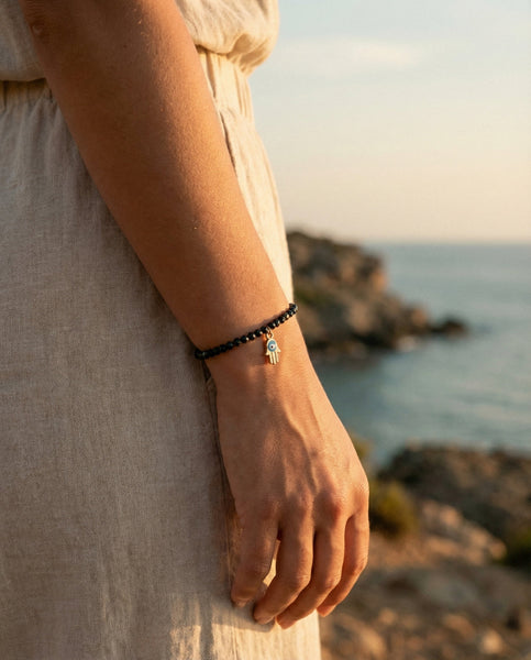 Handmade natural Black Obsidian healing bracelet for grounding and protection. A spiritual shield against negative energy, featuring genuine volcanic glass beads by Oneness Living. 100% vegan.