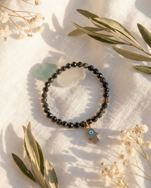 Handmade natural Black Obsidian healing bracelet for grounding and protection. A spiritual shield against negative energy, featuring genuine volcanic glass beads by Oneness Living. 100% vegan.