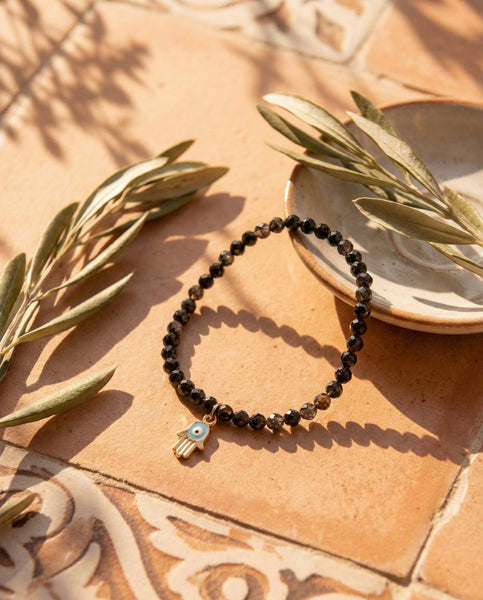 Handmade natural Black Obsidian healing bracelet for grounding and protection. A spiritual shield against negative energy, featuring genuine volcanic glass beads by Oneness Living. 100% vegan.