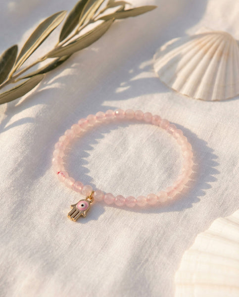Handmade natural Rose Quartz healing bracelet with soft pink gemstone beads. A spiritual jewelry piece for unconditional love, self-care, and Heart Chakra healing by Oneness Living. 100% vegan.