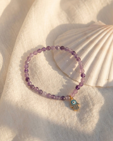 Handmade natural Amethyst healing bracelet with deep purple gemstone beads. A spiritual jewelry piece for intuition, meditation, and Crown Chakra healing by Oneness Living. 100% vegan.