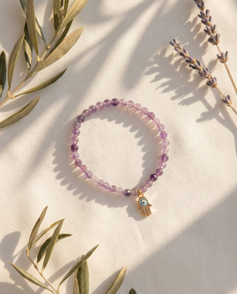 Handmade natural Amethyst healing bracelet with deep purple gemstone beads. A spiritual jewelry piece for intuition, meditation, and Crown Chakra healing by Oneness Living. 100% vegan.